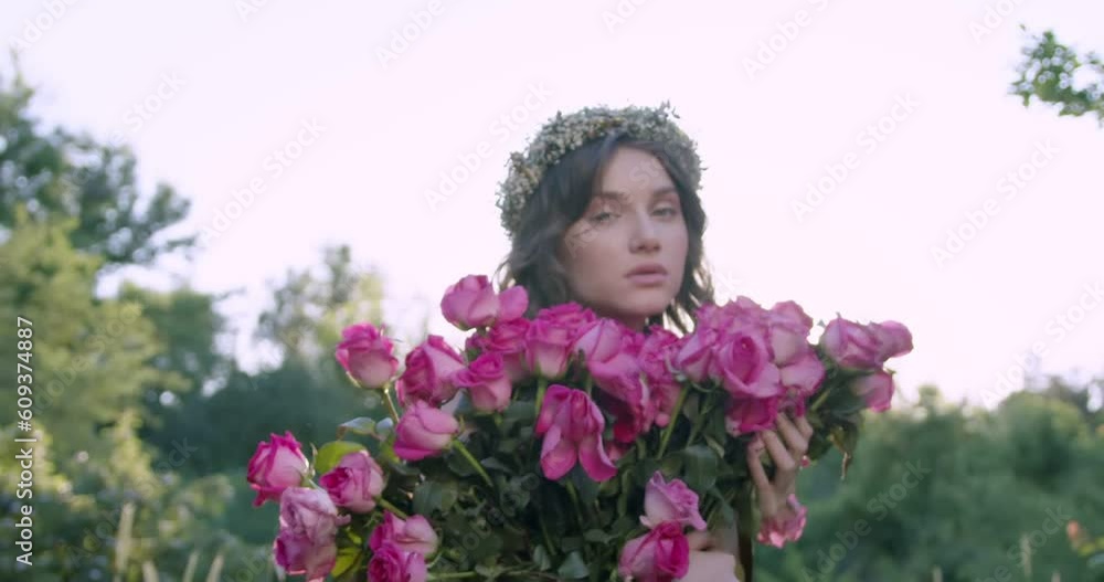 Girl with a wreath of flowers holds a bouquet Girl with a wreath of flowers holds a bouquet