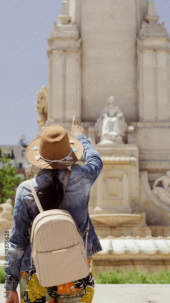 young tourist woman in front of a statue in a Madrid square