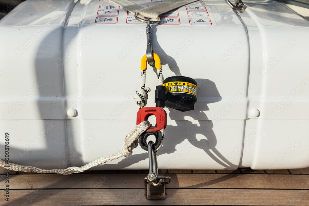 Life raft in capsules are fixed on the teak deck of the yacht in close ...