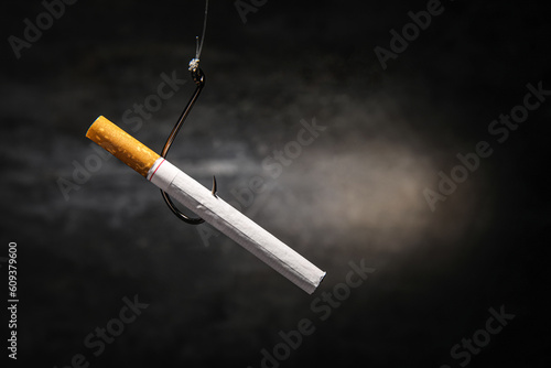 Cigarette hanging on hook a...