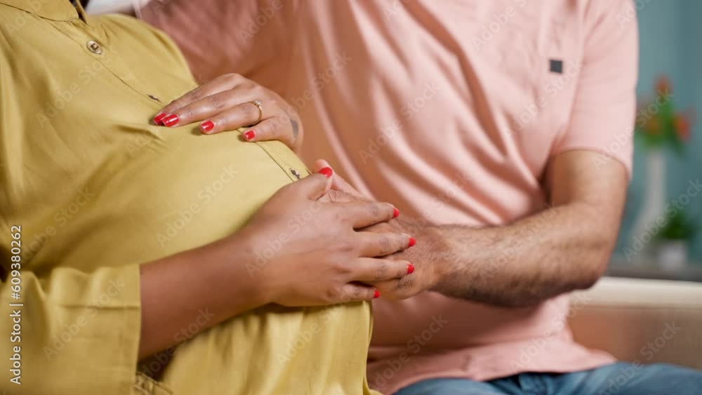 Close up shot of husband holding feeling by touching the belly of pregnant wife at home - concept of parenthood, affectionate and expecting. Close up shot of husband holding feeling by touching the belly of pregnant wife at home - concept of parenthood, affectionate and expecting.