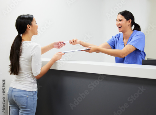 Documents, reception and a nurse helping a patient in the hospital during an appointment or checkup. Application form, happy and a woman medical assistant at a health clinic for check in or sign up