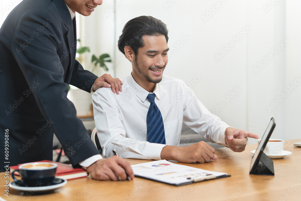 financial advisory services. Asian advisor showing plan of investment to clients in the consultancy office. financial advisory services. Asian advisor showing plan of investment to clients in the consultancy office.