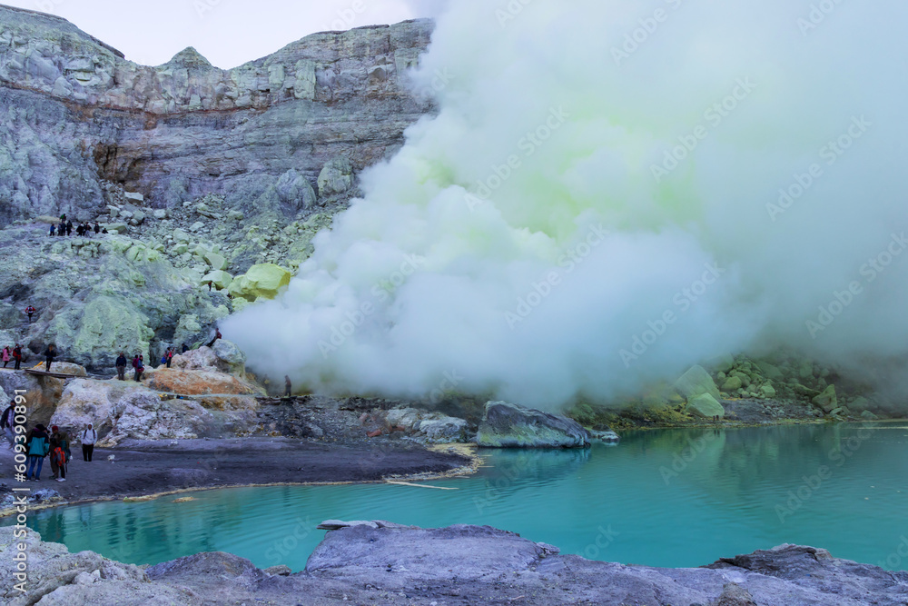 Fototapeta premium Beautiful landscape mountain and turquoise lake with smoke sulfur in the morning. The world's largest acidic lake,inside the crater of Kawah Ijen volcano in East Java, Indonesia. 