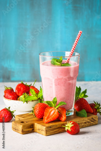 Strawberry smoothie or milkshake with fresh berries.