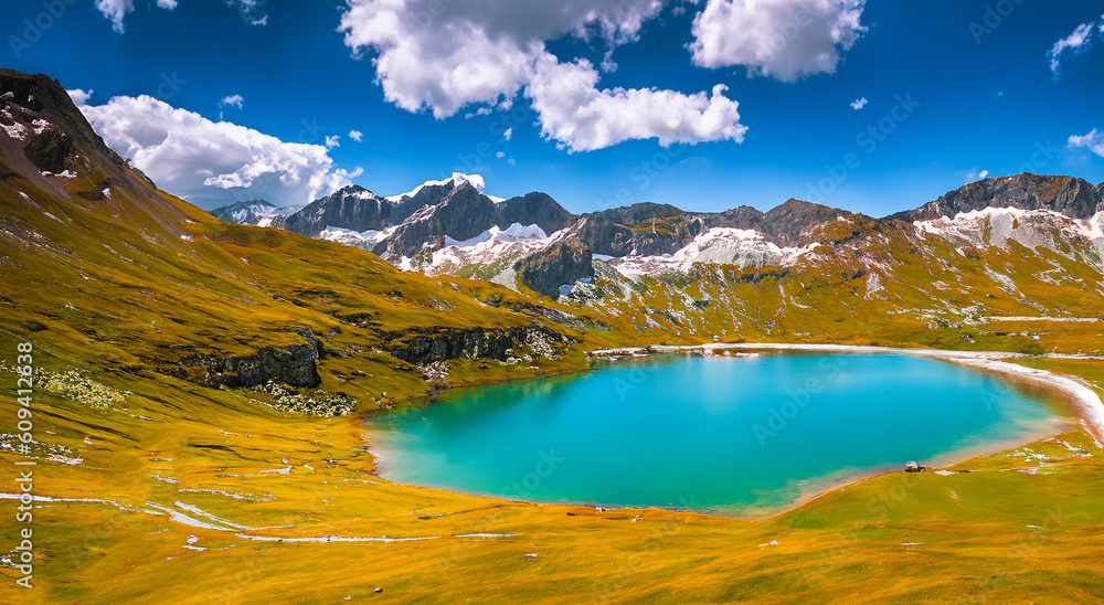 Fototapeta premium Beautiful autumn landscape with a large lake and a green mountain in the background with a green meadow