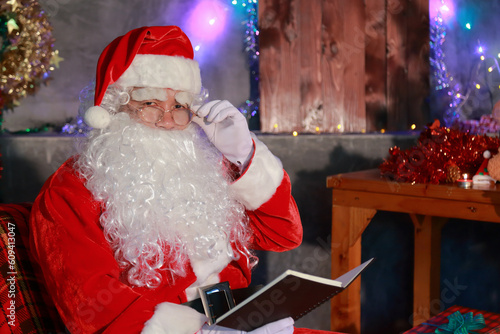 Christmas concept. Portrait of a fairytale Santa Claus. Beautiful house decorated for Christmas. Time of miracles.