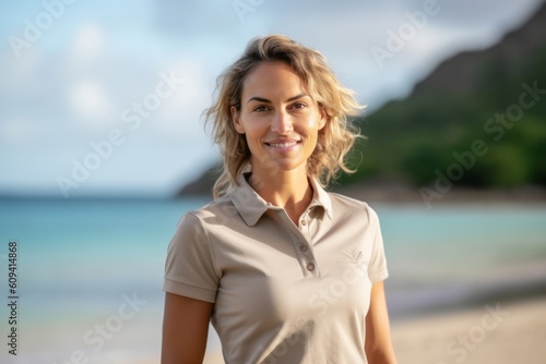Portrait of a beautiful young woman standing on the beach and smiling