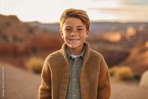 Cute little boy in warm sweater on blurred background of Grand Canyon