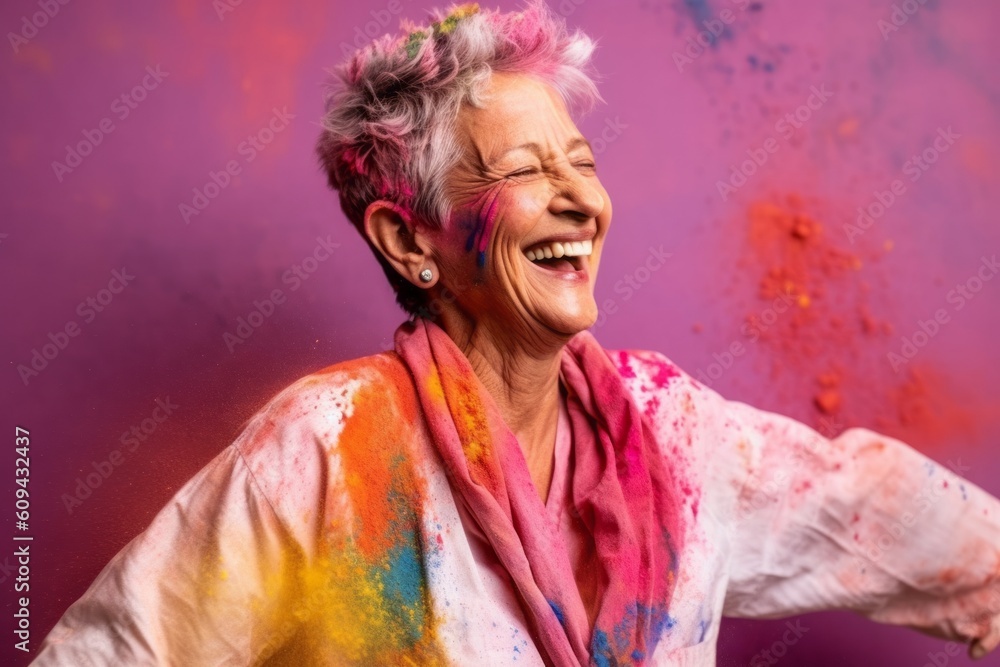 Medium shot portrait photography of a satisfied woman in her 60s that is wearing a comfortable tracksuit against a colorful holi festival celebration with powder thrown background . Generative AI
