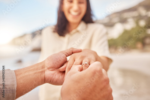 Pov, engagement and woman with ring on hand at beach with smile, love and happy couple vacation. Man, woman and jewelry with marriage offer by ocean with diamond, excited face or together on holiday