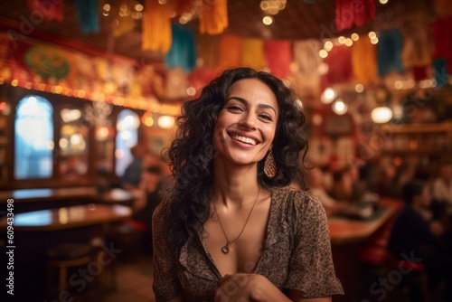 Portrait of a beautiful woman smiling at the camera in a restaurant © Robert MEYNER