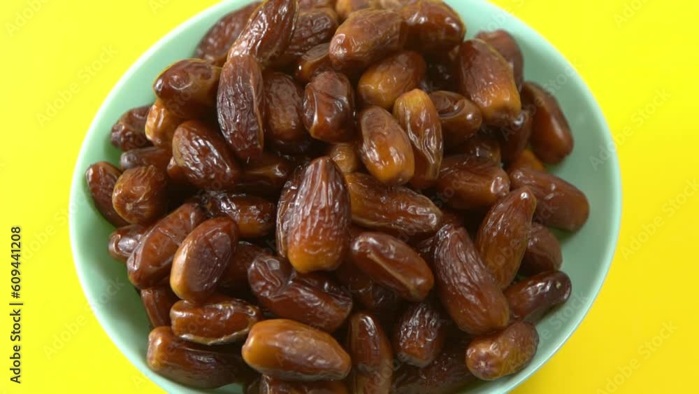 Dates. Dried date palm fruits. Healthy sweet snack food bowl. Pile of tasty dry dattes in plate. Date harvest symbolizing Ramadan. Dates. Dried date palm fruits. Healthy sweet snack food bowl. Pile of tasty dry dattes in plate. Date harvest symbolizing Ramadan.