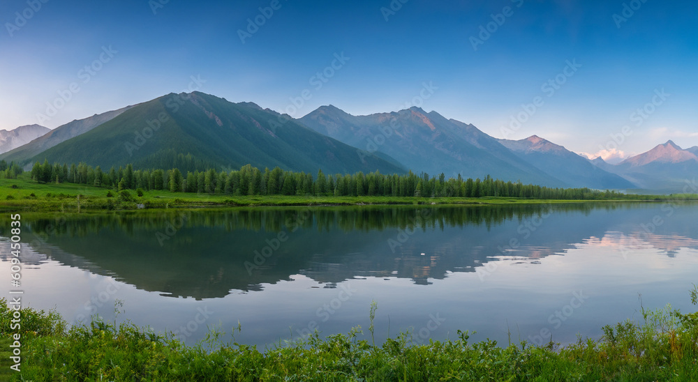 beautiful landscape of a lake surrounded by big mountains by day