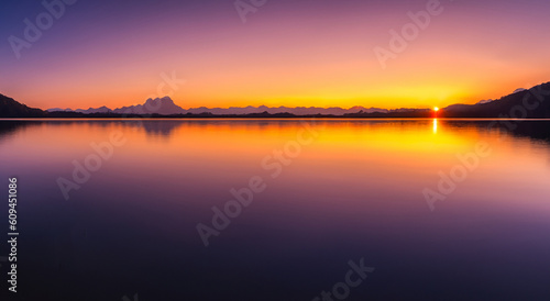 beautiful landscape in the autumn sunset with a lake reflected the sky