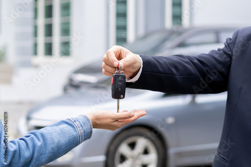 Bild auf Leinwand Business car rental, sell or buy service, dealership hand of agent dealer, sale young woman giving auto key of vehicle to customer renter, buyer man receiving, client or tenant, transfer automobile