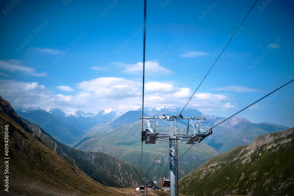 Mountain ranges on a sunny day at Georgia. Funicular in the mountains of georgia. Mountain cable car in summer