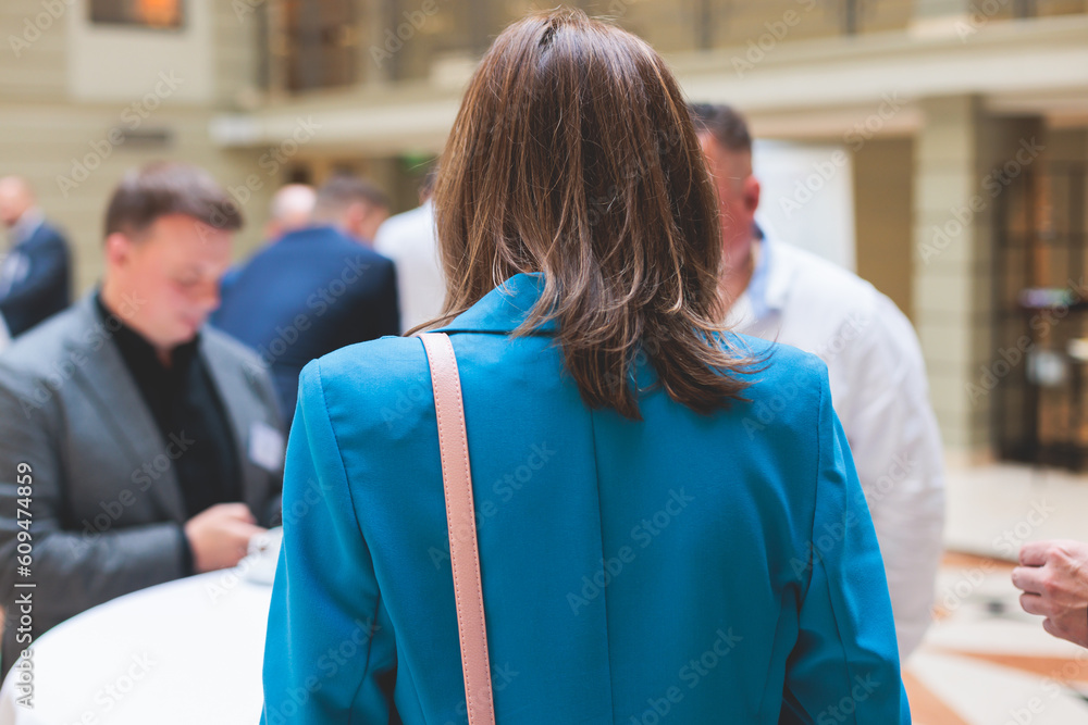 Obraz premium Group of women in business suits talking and discussing during coffee break at conference, female politicians and entrepreneurs networking and negotiate, businesswomen dialog conversation on forum