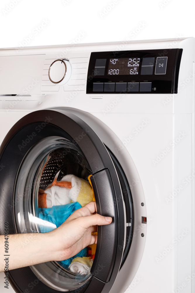 The hand select settings for laundry on modern digital display. Close-up view of automatic washing machine with touch screen on control panel. Press start or pause The hand select settings for laundry on modern digital display. Close-up view of automatic washing machine with touch screen on control panel. Press start or pause