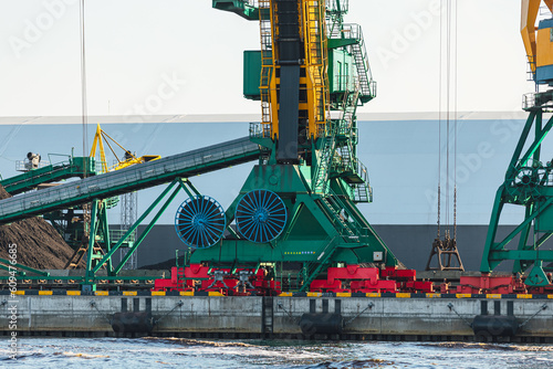 Larger cranes in the port, cranes load bulk materials. The work of cranes in the seaport photo