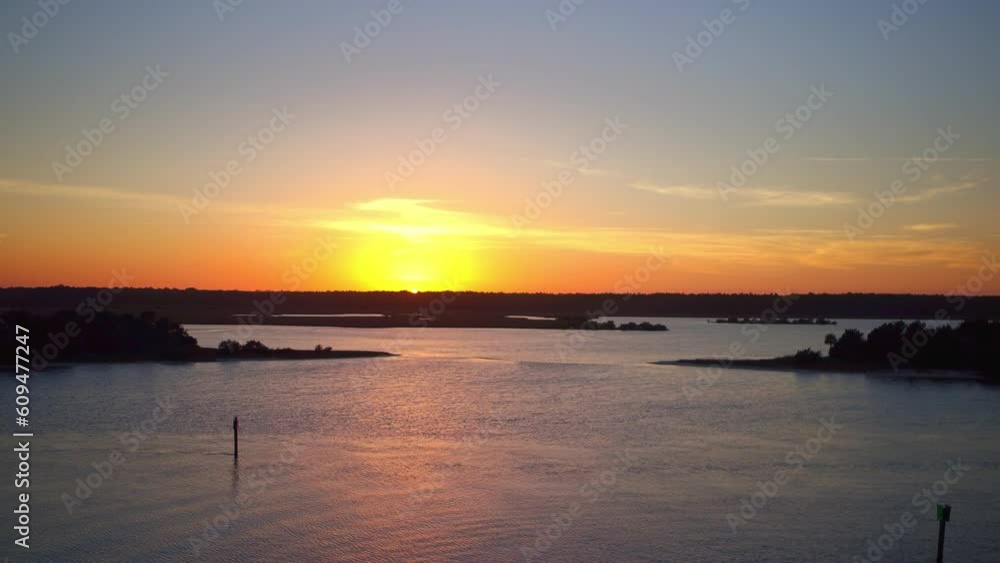 Aerial Shot Of Silhouette Plants And Trees By Sea Against Sky, Drone Ascending Over Natural Landscape At Sunset - Daytona Beach, Florida Aerial Shot Of Silhouette Plants And Trees By Sea Against Sky, Drone Ascending Over Natural Landscape At Sunset - Daytona Beach, Florida