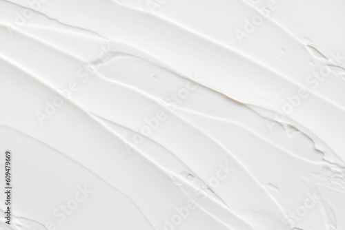 Swatch of white cream texture, cosmetics for face and body on a isolated light grey background. Smear.  Real photo photo