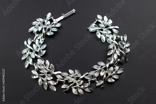 Beautiful old silver leaves bracelet, unique vintage jewelry background, floral jewelry concept, promotional photo for an online jewellery store