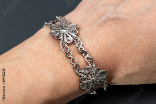 Old silver filigree flowers bracelet, unique vintage jewelry background, promotional photo for an online jewellery store