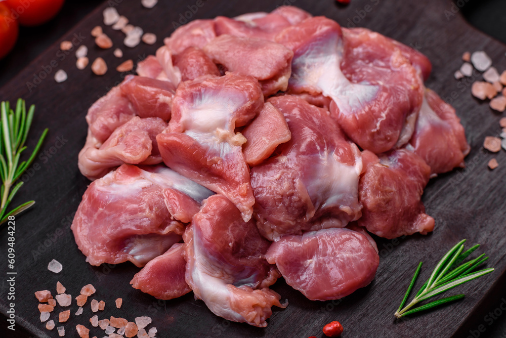 Raw chicken or turkey gizzards with salt, spices and herbs Raw chicken or turkey gizzards with salt, spices and herbs