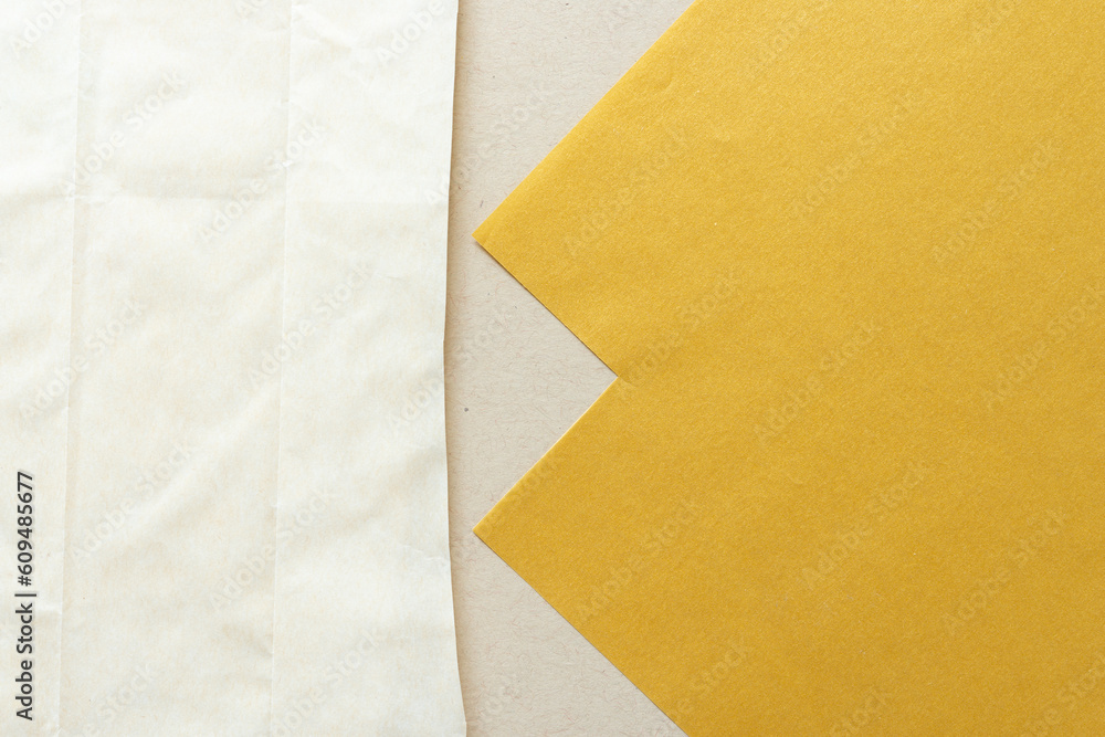 cut paper and parchment paper bag on beige cut paper and parchment paper bag on beige