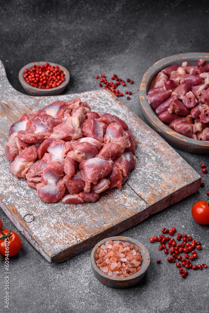 Raw chicken or turkey gizzards with salt, spices and herbs Raw chicken or turkey gizzards with salt, spices and herbs