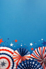 Celebration concept for America's Fourth of July holiday. Top view flat lay of patriotic party decorations, celebration confetti on blue background with empty space for advertisement or text