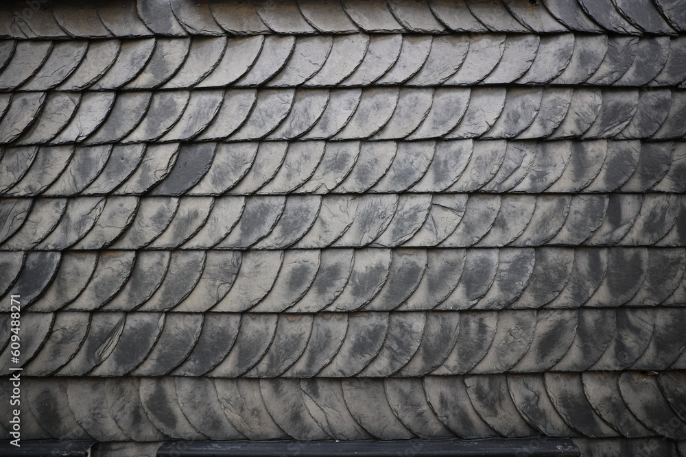 Black tiles on the wall closeup image, cover of half-timbered fachwerk house closeup typical german building Black tiles on the wall closeup image, cover of half-timbered fachwerk house closeup typical german building