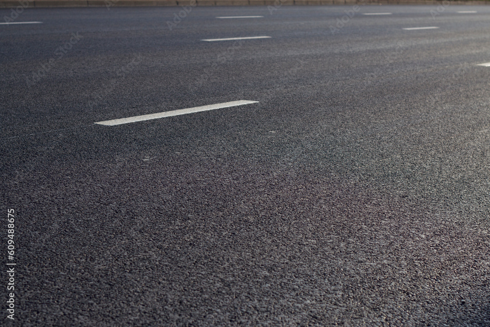 new asphalt road with lines as a dark background new asphalt road with lines as a dark background