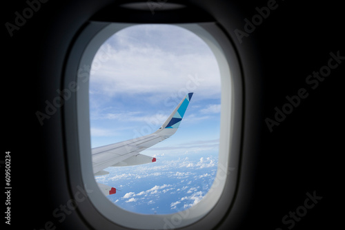 Looking through aircraft window during flight on the wing with a nice blue sky