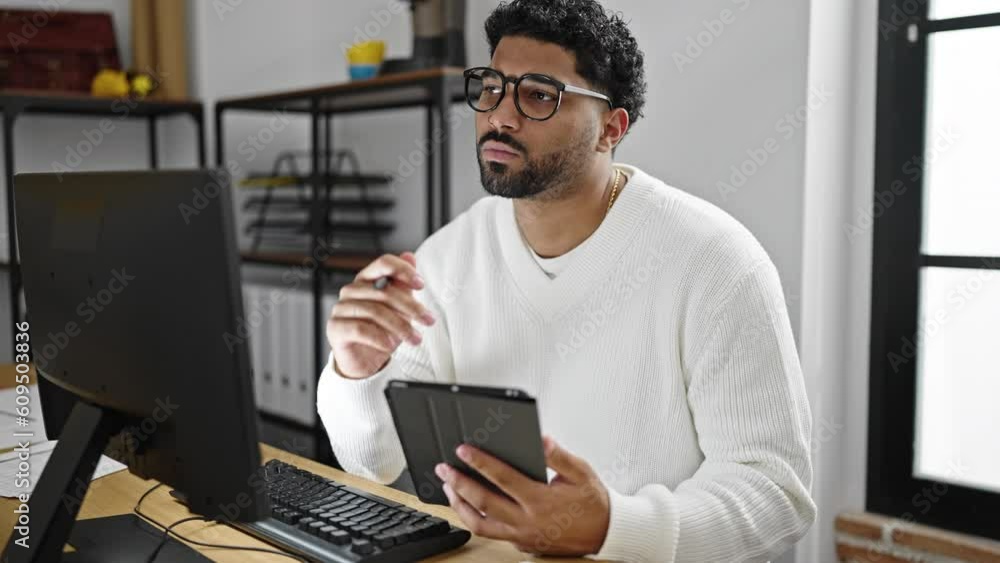 African american man business worker using computer and touchpad working at office African american man business worker using computer and touchpad working at office