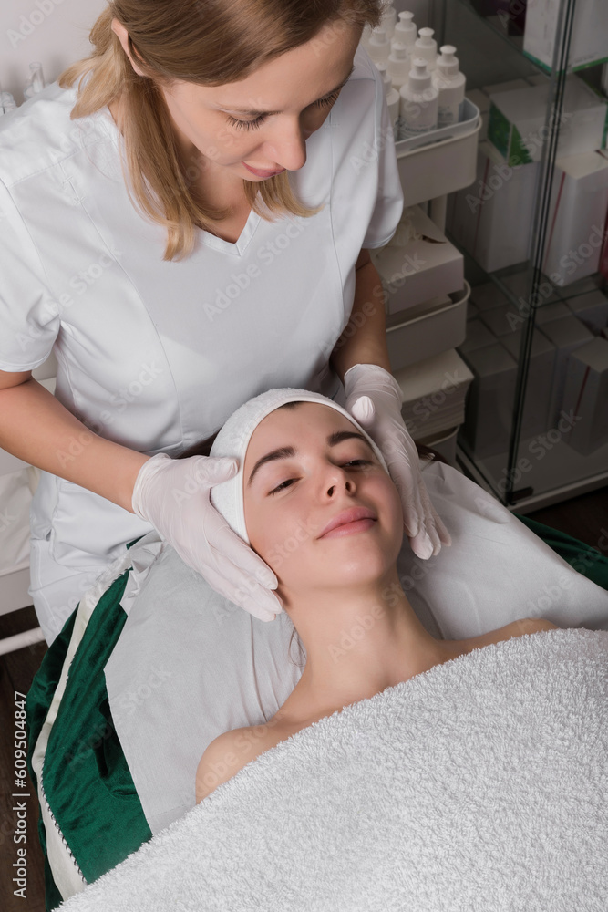 Young woman enjoying massage in beauty salon. Young woman enjoying massage in beauty salon.