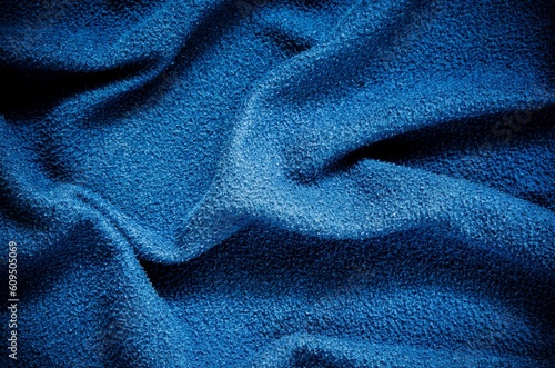Blue wrinkled fabric texture. Close-up of soft cotton cloth, may be used as background.