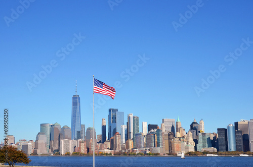 The American flag and the Hudson River and Manhattan in the background during the day