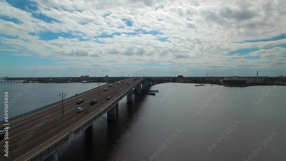 Aerial Shot Of Vehicles On Bridge Over Sea Against Cloudy Sky, Drone Flying Backward Over City On Sunny Day - Daytona Beach, Florida Aerial Shot Of Vehicles On Bridge Over Sea Against Cloudy Sky, Drone Flying Backward Over City On Sunny Day - Daytona Beach, Florida