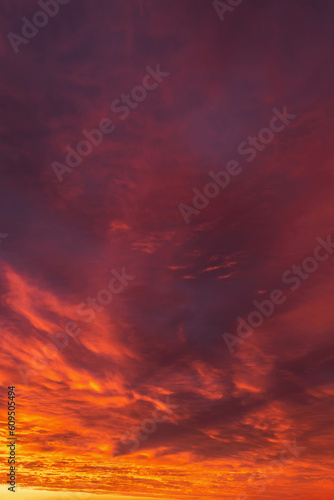 Epic dramatic sunrise, sunset orange red yellow clouds in sunlight abstract background texture