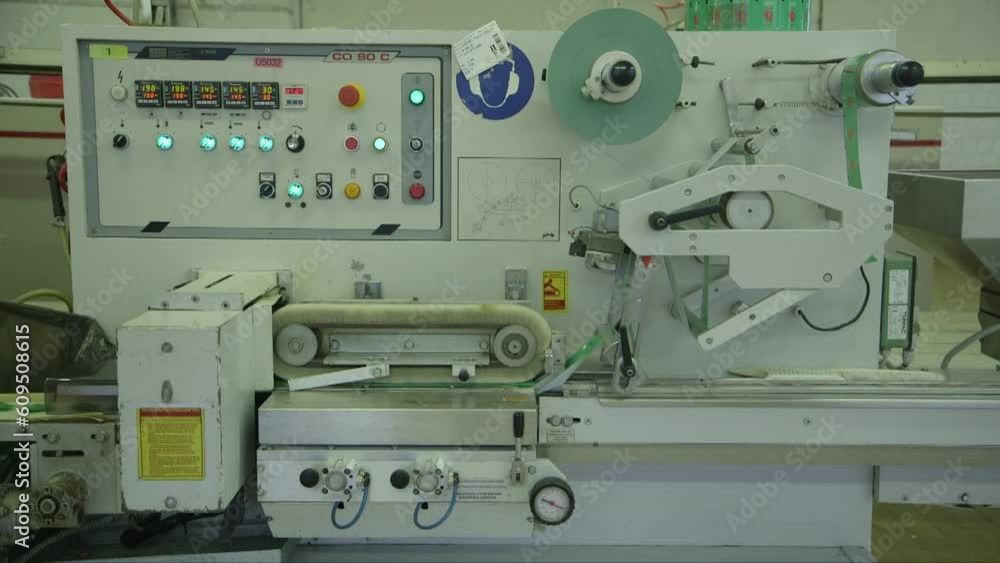 static wide shot of very fast lollipop packing machine in candy factory static wide shot of very fast lollipop packing machine in candy factory