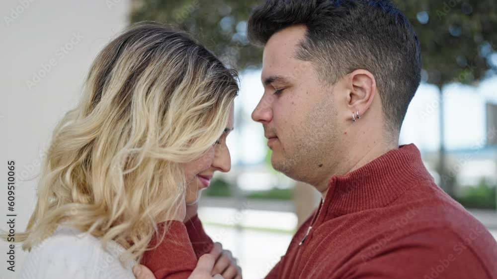 Man and woman couple smiling confident kissing on head at street Man and woman couple smiling confident kissing on head at street
