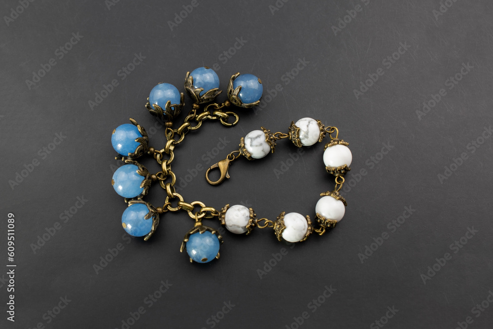 Beautiful gemstone charm chain bracelet, unique handmade stone bead jewelry background, promotional photo for an online jewellery store Beautiful gemstone charm chain bracelet, unique handmade stone bead jewelry background, promotional photo for an online jewellery store