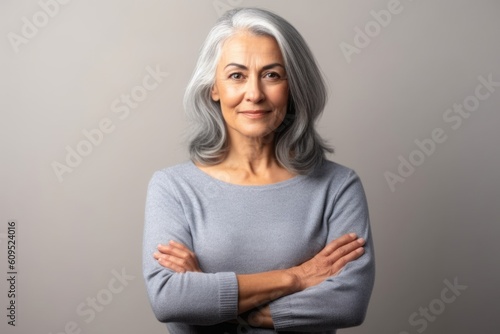Smiling beautiful attractive woman looking at the camera of gray background. Generative AI