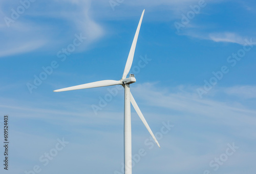 Close up of three blades of a wind turbine with a blue sky. © Margaret Burlingham