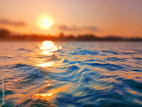 Sea wave splash, sunset blurred bokeh background, ocean water surf ripple texture, sunrise soft focus, tropical island beach dawn, sundown orange sun shine reflection, summer holiday, vacation, travel © Vera NewSib