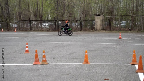 Young people learn to ride a motorbike in a motor school