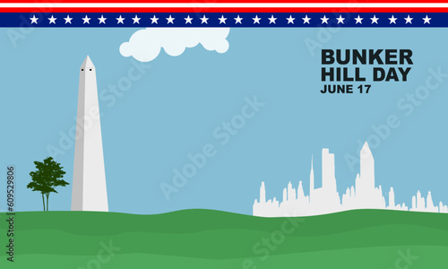 a bunker hill monument building with a tree and the silhouette of a BOSTON building in sunny weather commemorating BUNKER HILL DAY on June 17
