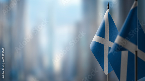 Bild auf Leinwand Small flags of the Scotland on an abstract blurry background